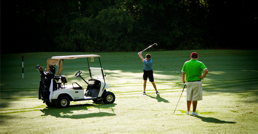 Golfers playing on course 